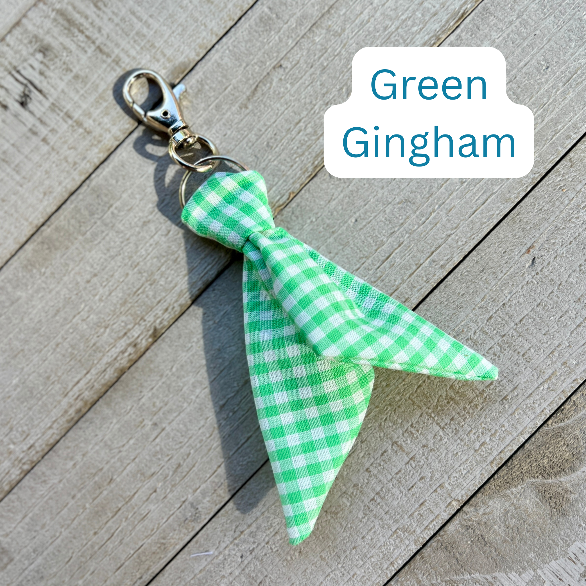 Green gingham bow keychain on a wooden surface with 'Green Gingham' text.
