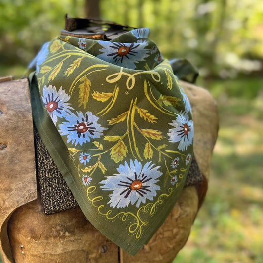 Floral patterned bandana on a wooden surface with a natural background
