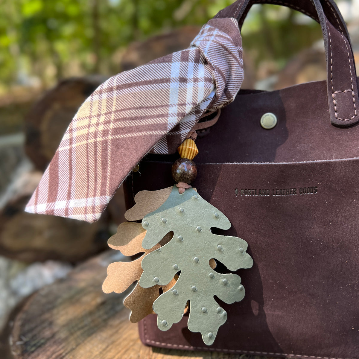green and tan oak leaves bag charm with plaid scarf on brown tote