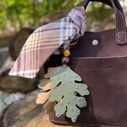 green and tan oak leaves bag charm with plaid scarf on brown tote