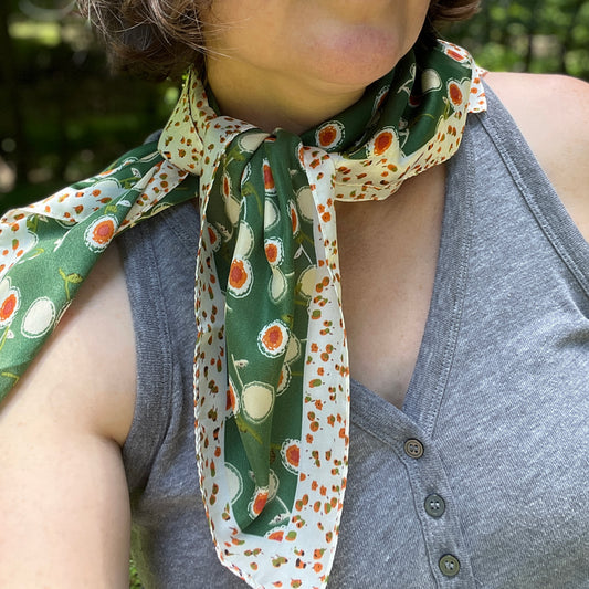 Person wearing a green floral patterned scarf