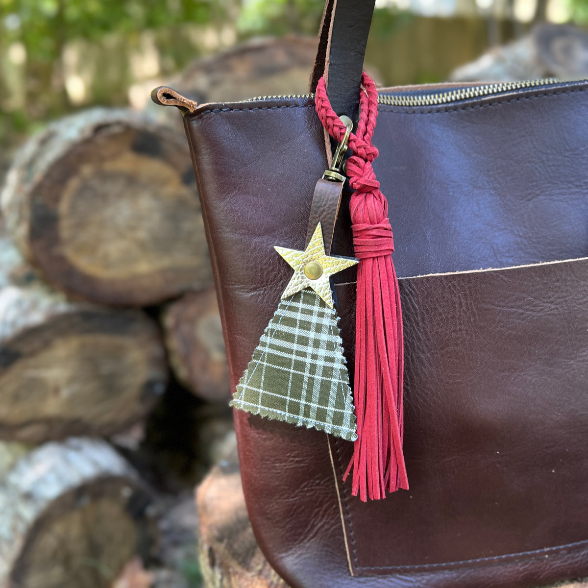 green plaid christmas tree charm with red tassel on brown tote