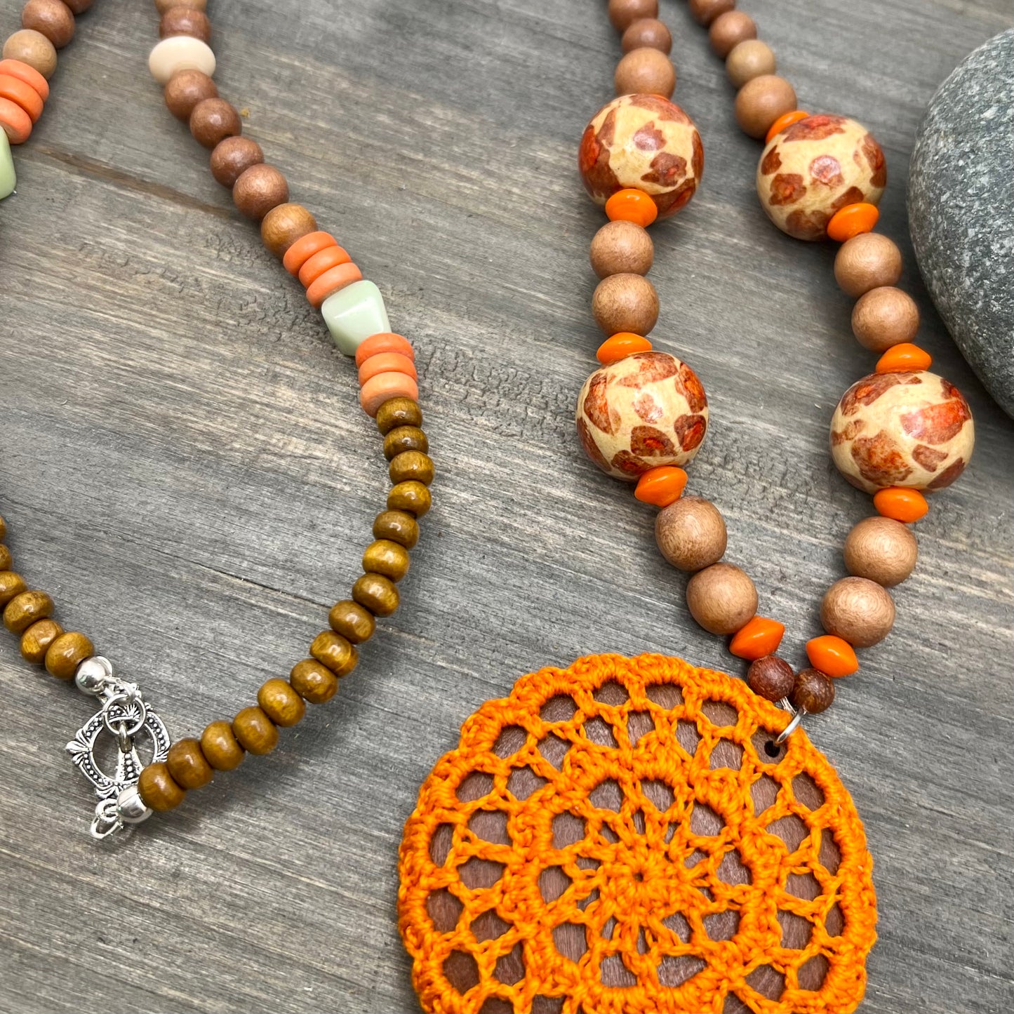 long wood bead necklace with bright orange pendant