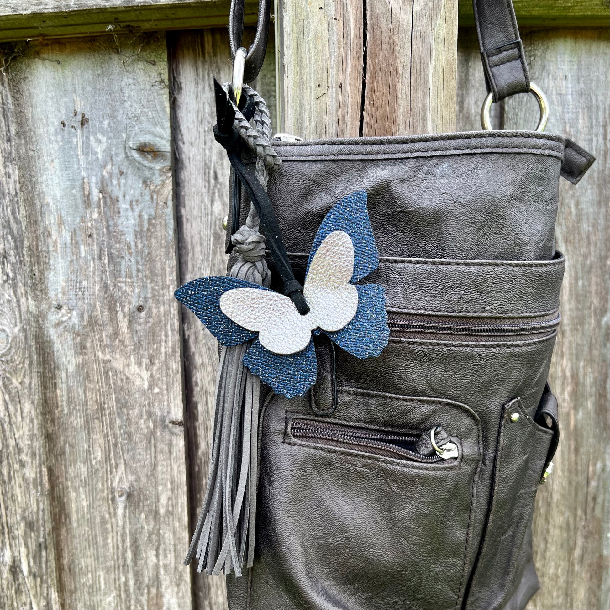 Leather Butterfly Bag CharmGenuine leather bag charms are the perfect way to update your bag, handbag, purse, tote or backpack. Butterflies are 4" wide and 3" tall. 5" faux suede loop can easily work with most straps and bag hardware. Handmade with genuin