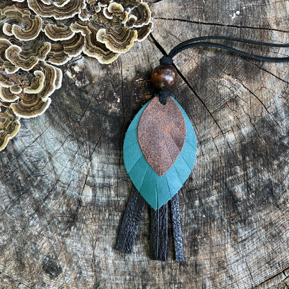 leather feather on black leather tassel with wooden beads