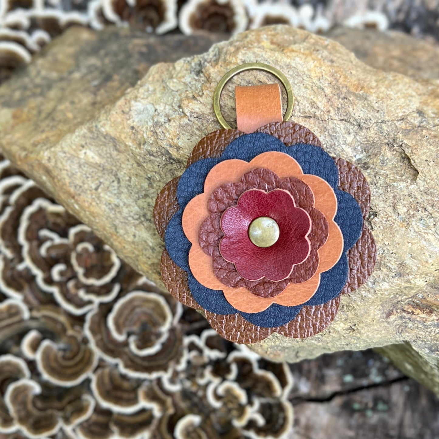 leather flower in brown, navy, red