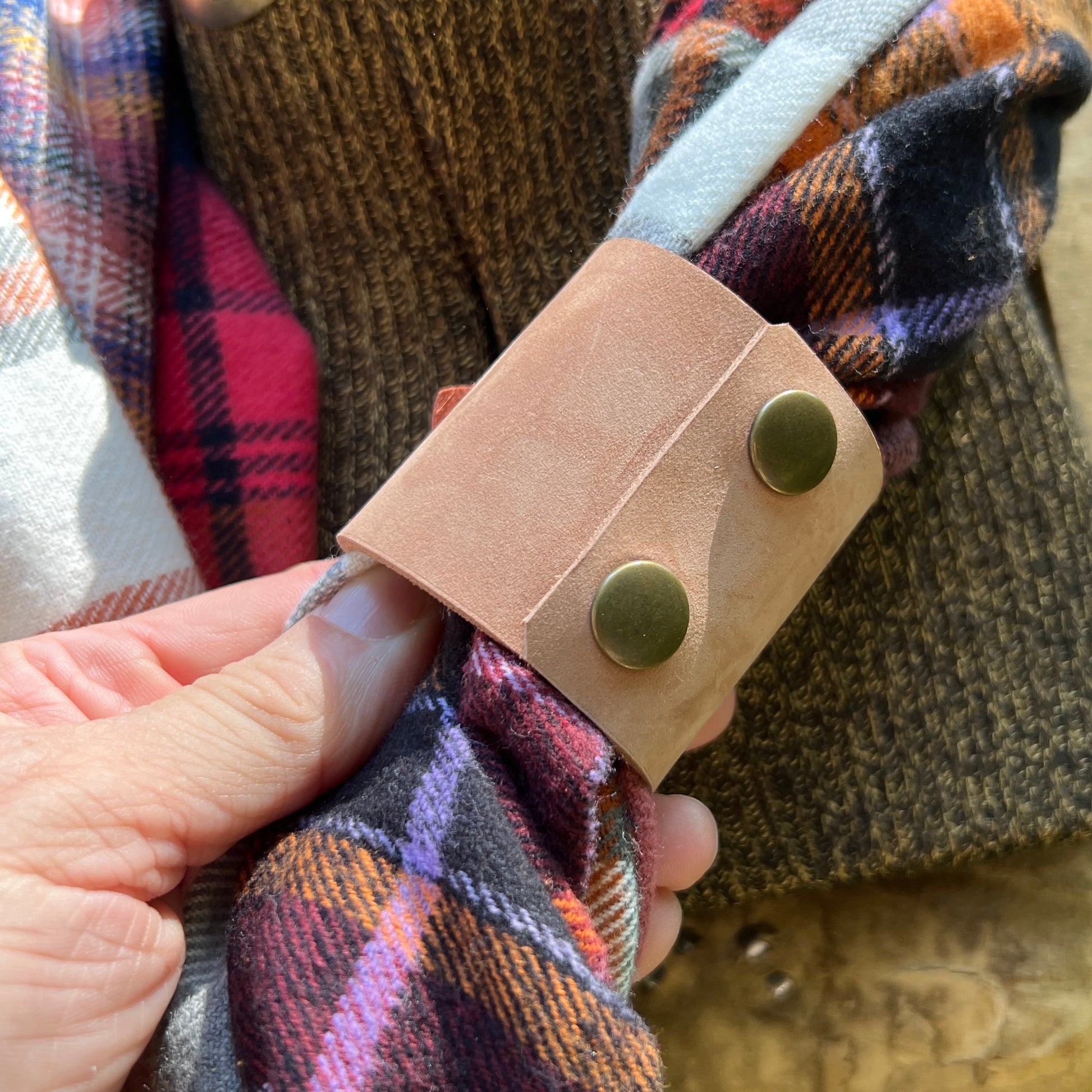 leather scarf cuff with orange flower on plaid flannel scarf backside snaps