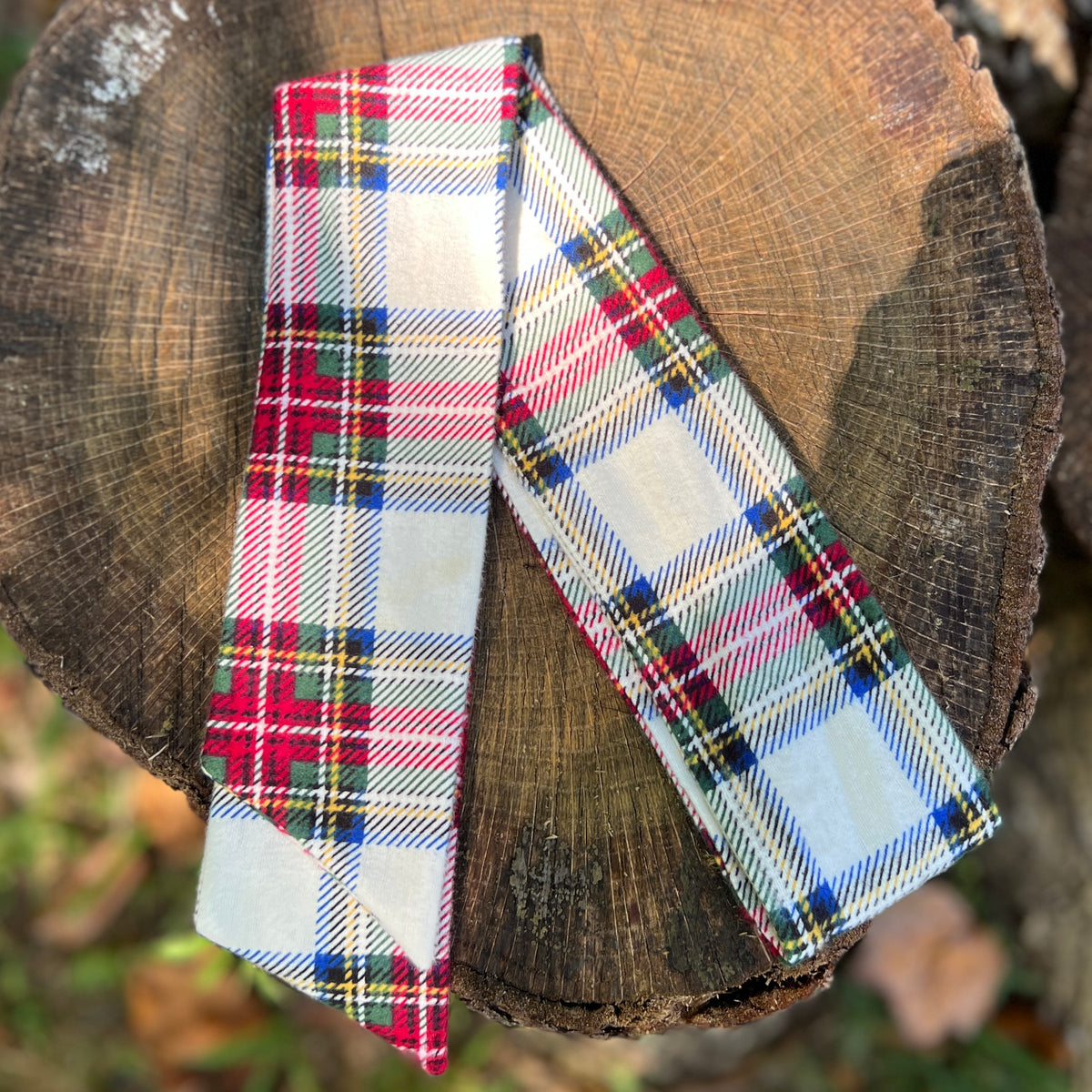 plaid holiday purse scarf on tree stump