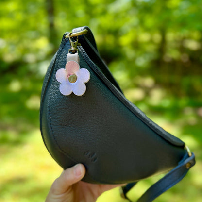 small flower purse charm on black purse