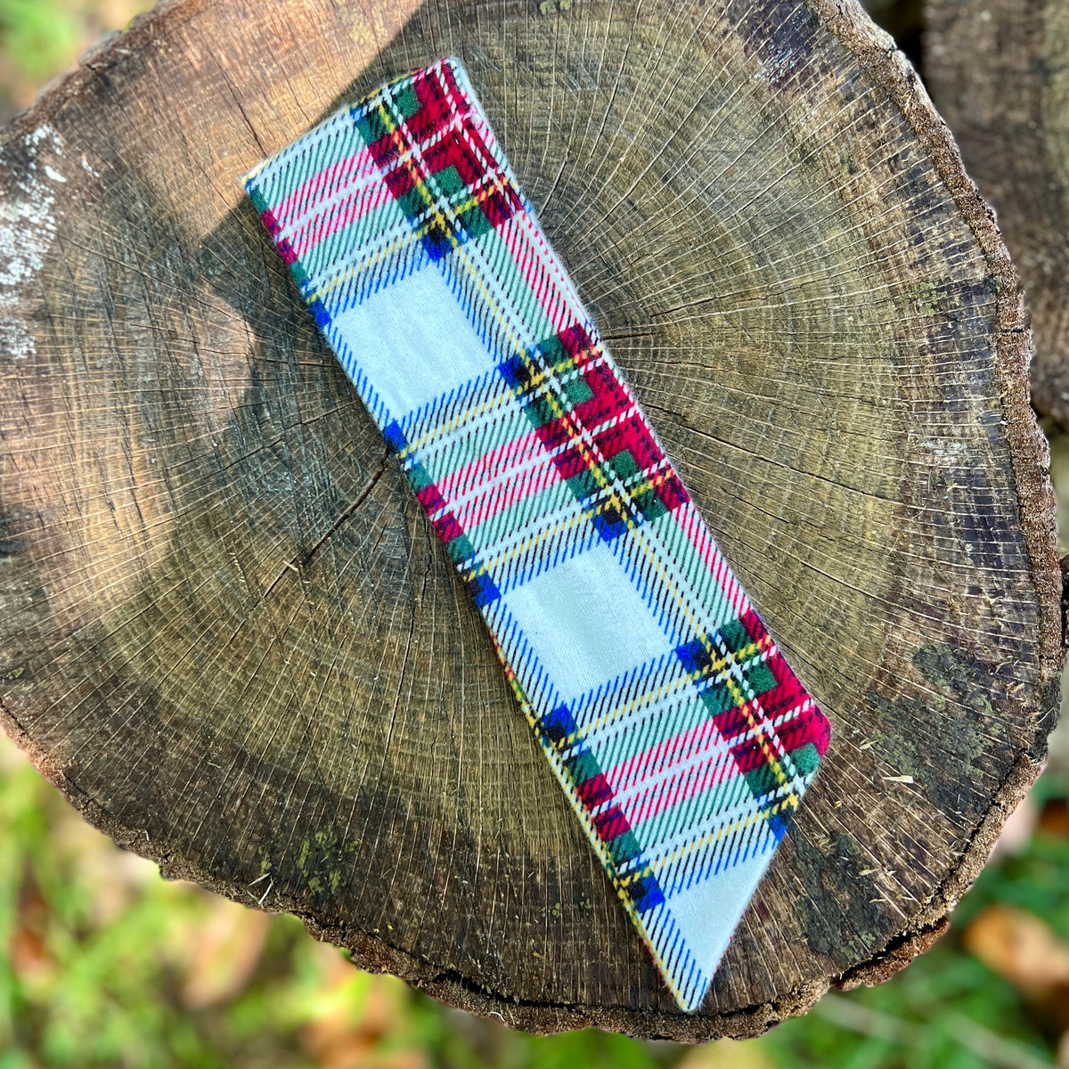 plaid holiday purse scarf on tree stump