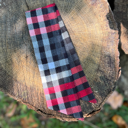 red and black plaid flannel purse scarf on wooden surface