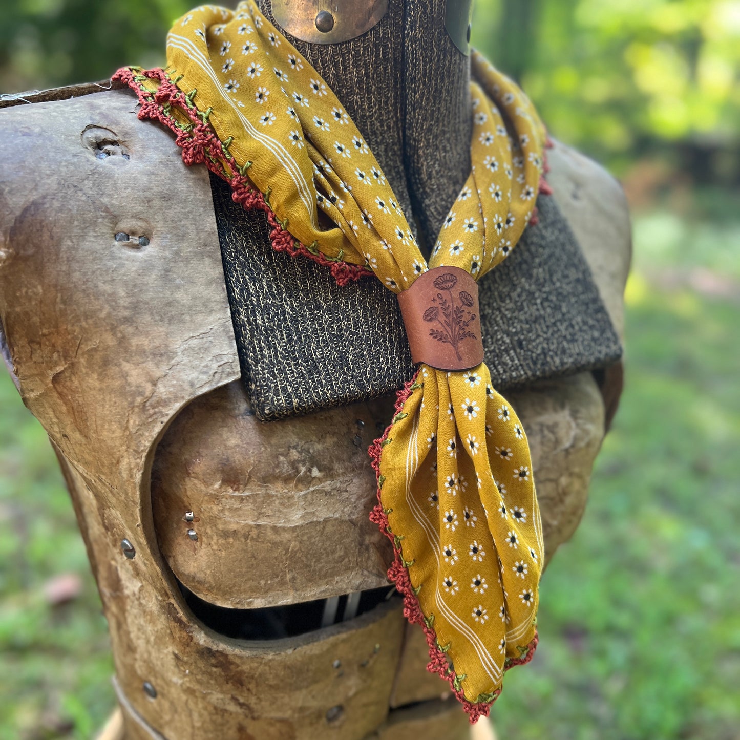 mustard yellow bandana with crochet trim and floral slide