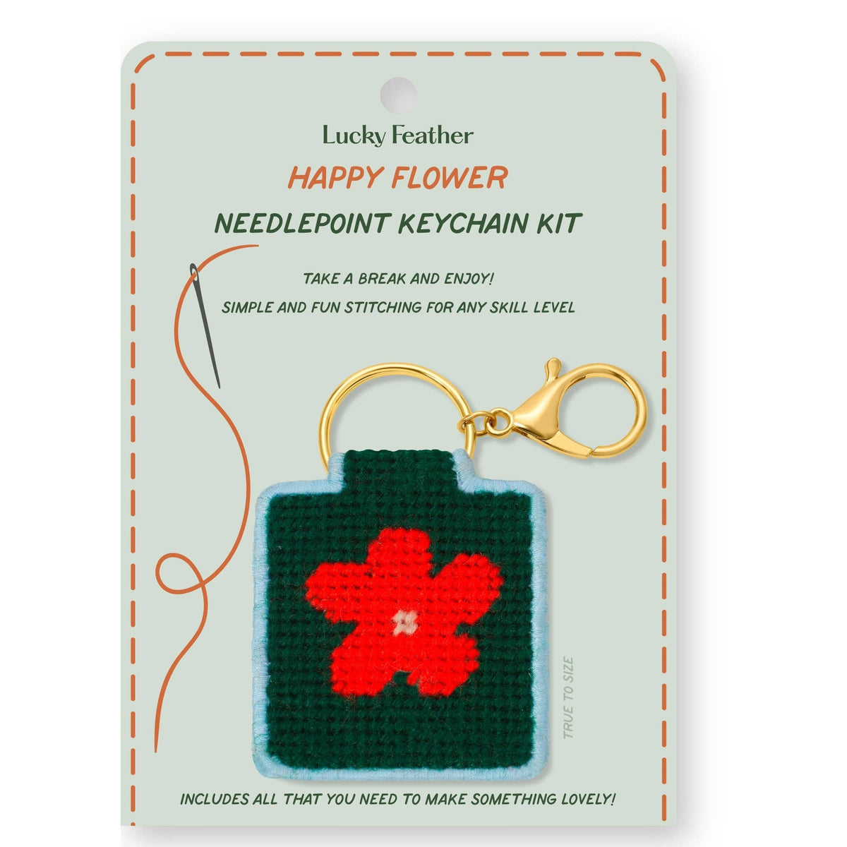 needlepoint keychain kit with happy flower on white background