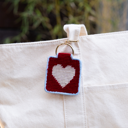 needlepoint keychain kit with red heart on white tote