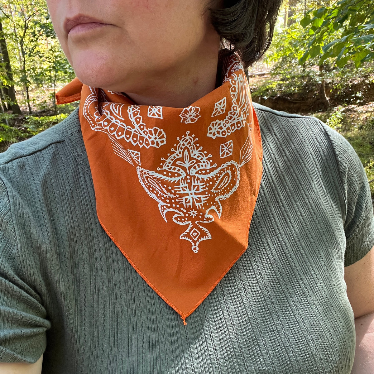 paisley bandana in orange on person with green shirt