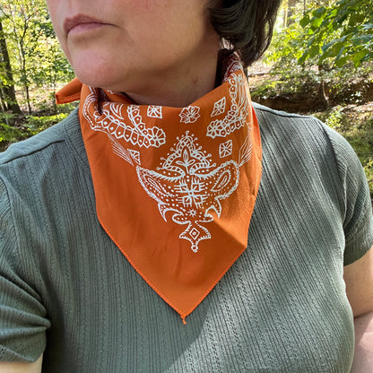paisley bandana in orange on person with green shirt