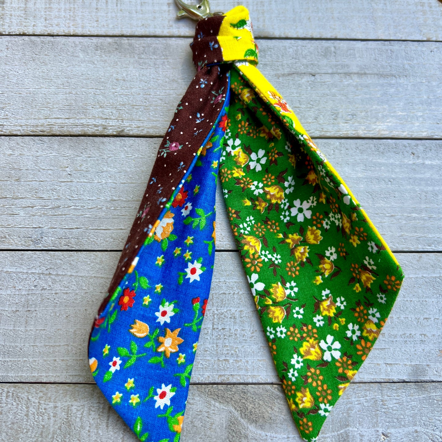 Floral-patterned fabric strips on a wooden surface