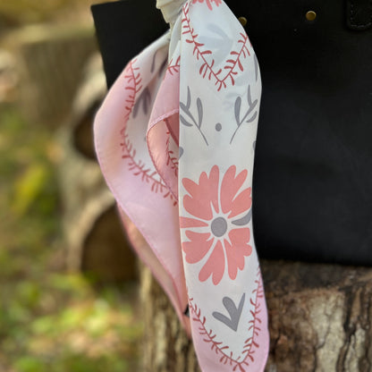 pink and gray floral square scarf on black bag