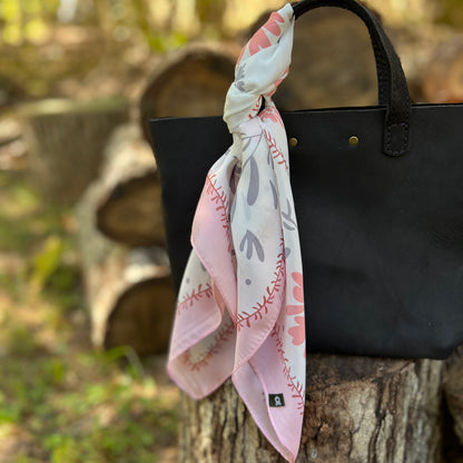 pink and gray floral square scarf on black tote