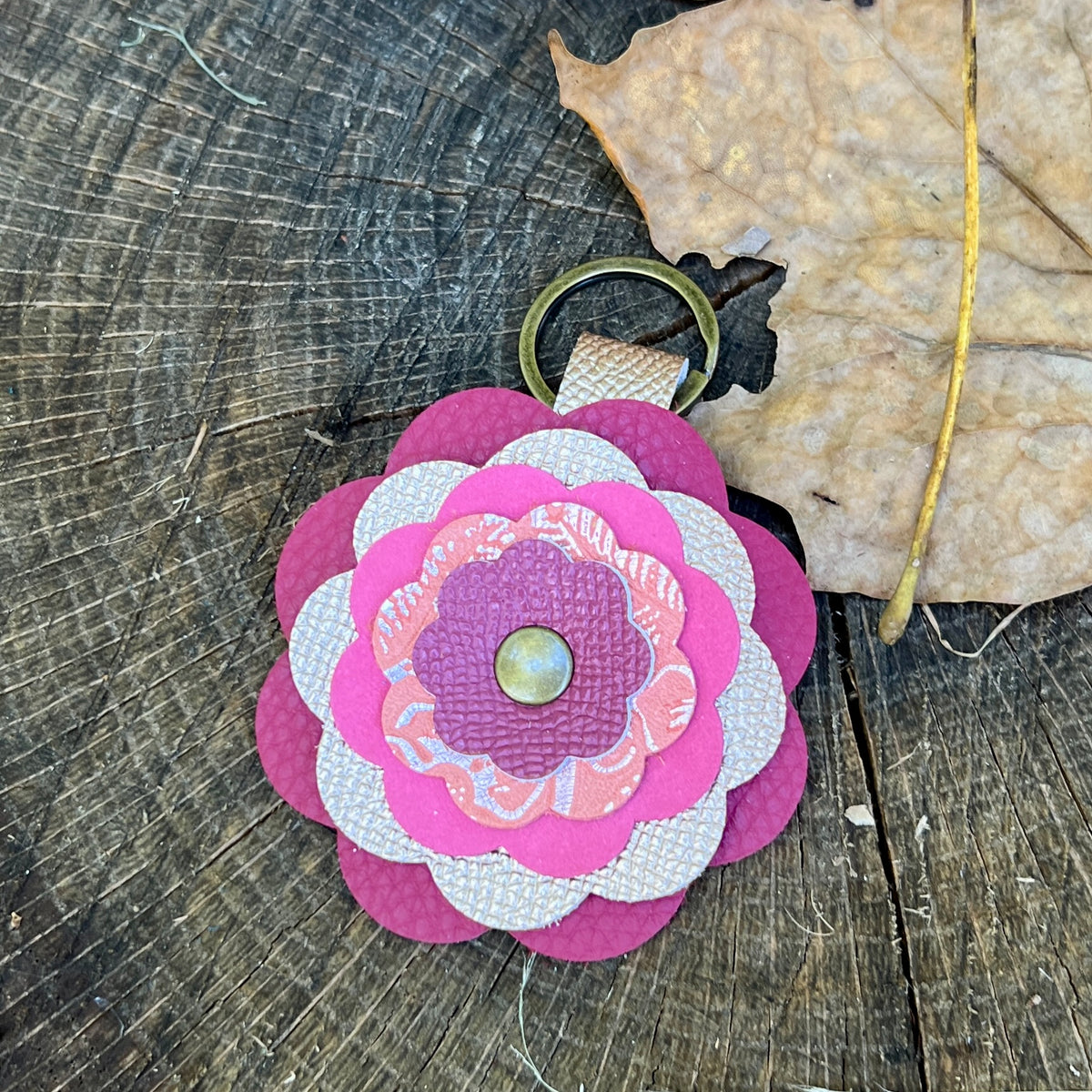 pink flower bag charm on wooden surface