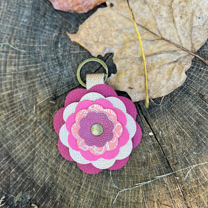 pink flower bag charm on wooden surface