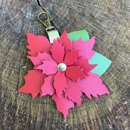 poinsettia flower bag charm on wood surface