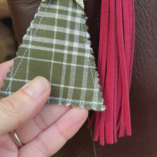 green plaid christmas tree charm with red tassel on brown tote