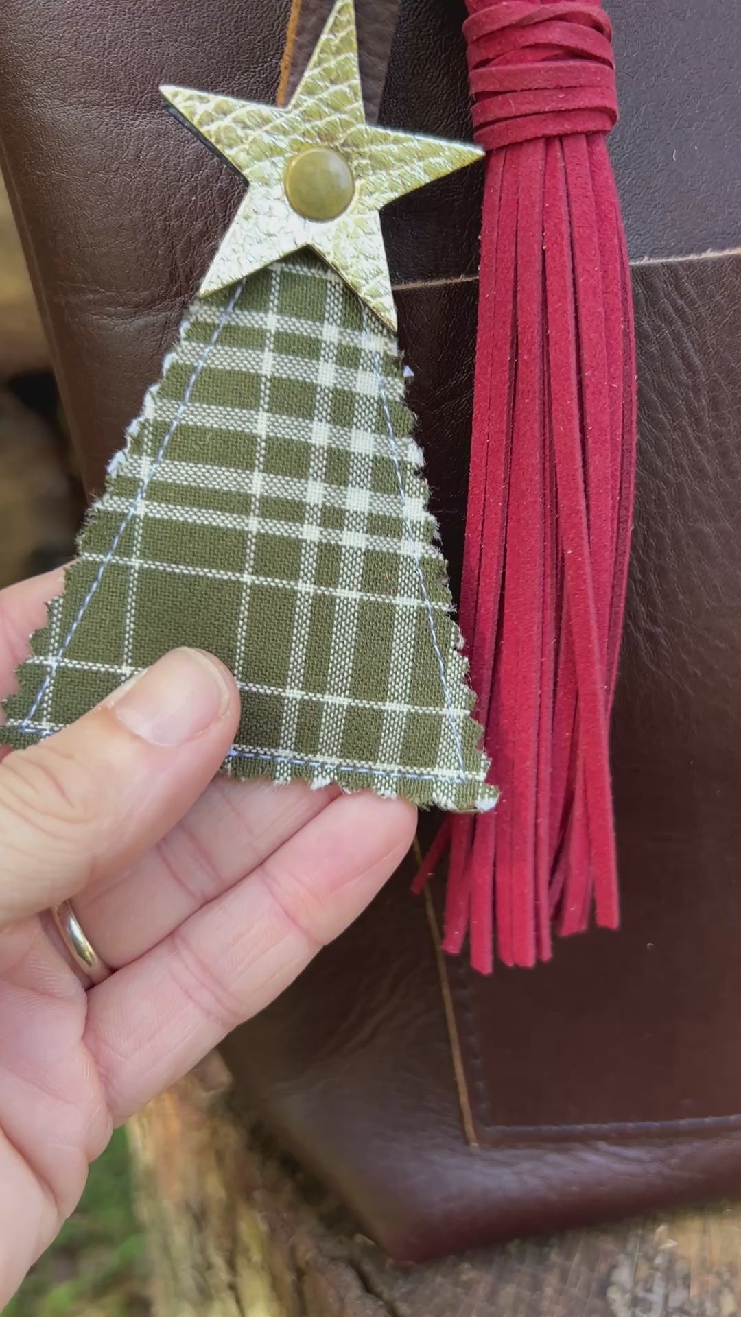 green plaid christmas tree charm with red tassel on brown tote