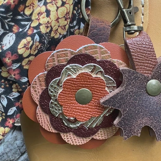 autumn orange layered leather flower bag charm with brown leaf charm and floral scarf on sunflower yellow handbag