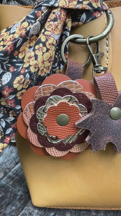 autumn orange layered leather flower bag charm with brown leaf charm and floral scarf on sunflower yellow handbag