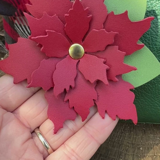 red flower bag charm on green bag