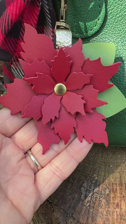 red flower bag charm on green bag