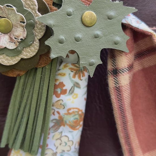 green and brown layered bag charms on brown tote