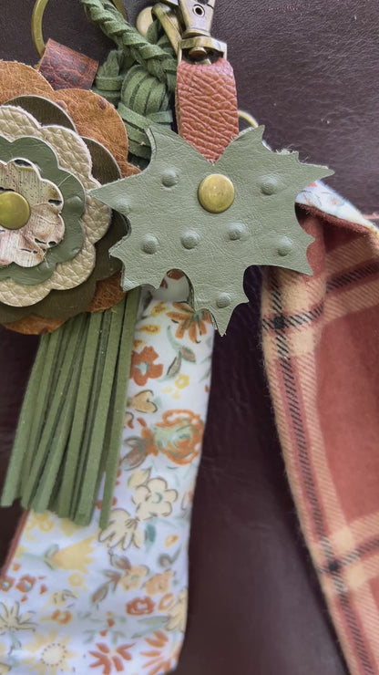 green and brown layered bag charms on brown tote