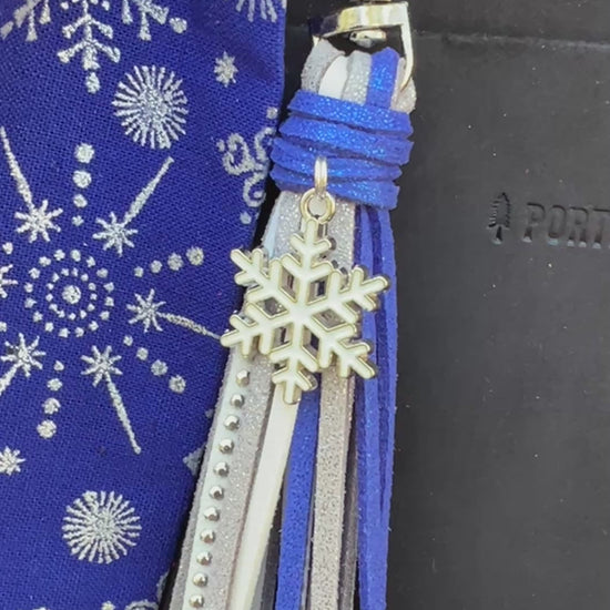 blue and silver bag charms on black bag