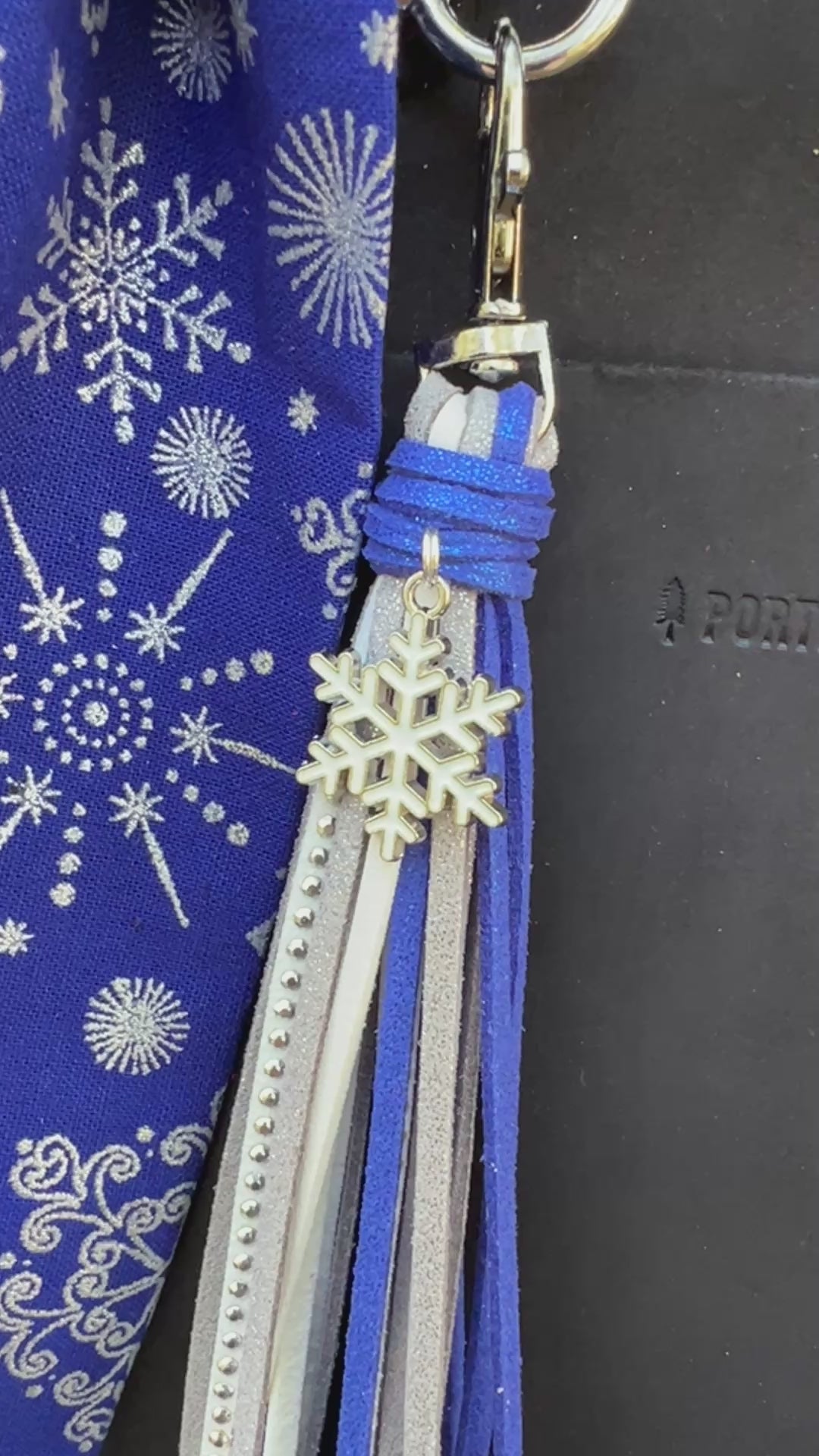 blue and silver bag charms on black bag