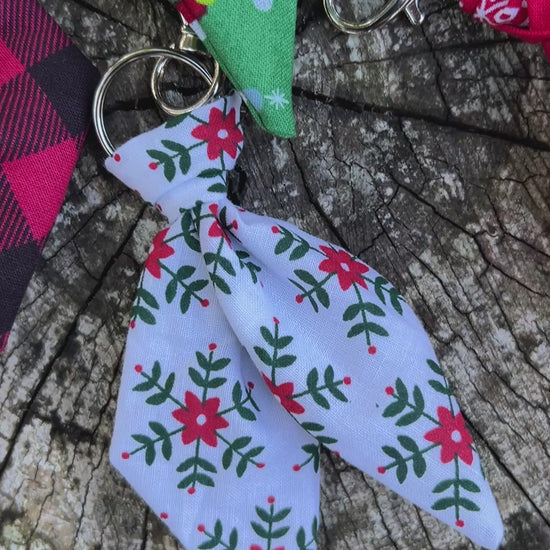 Christmas print mini scarf keychains on wooden surface