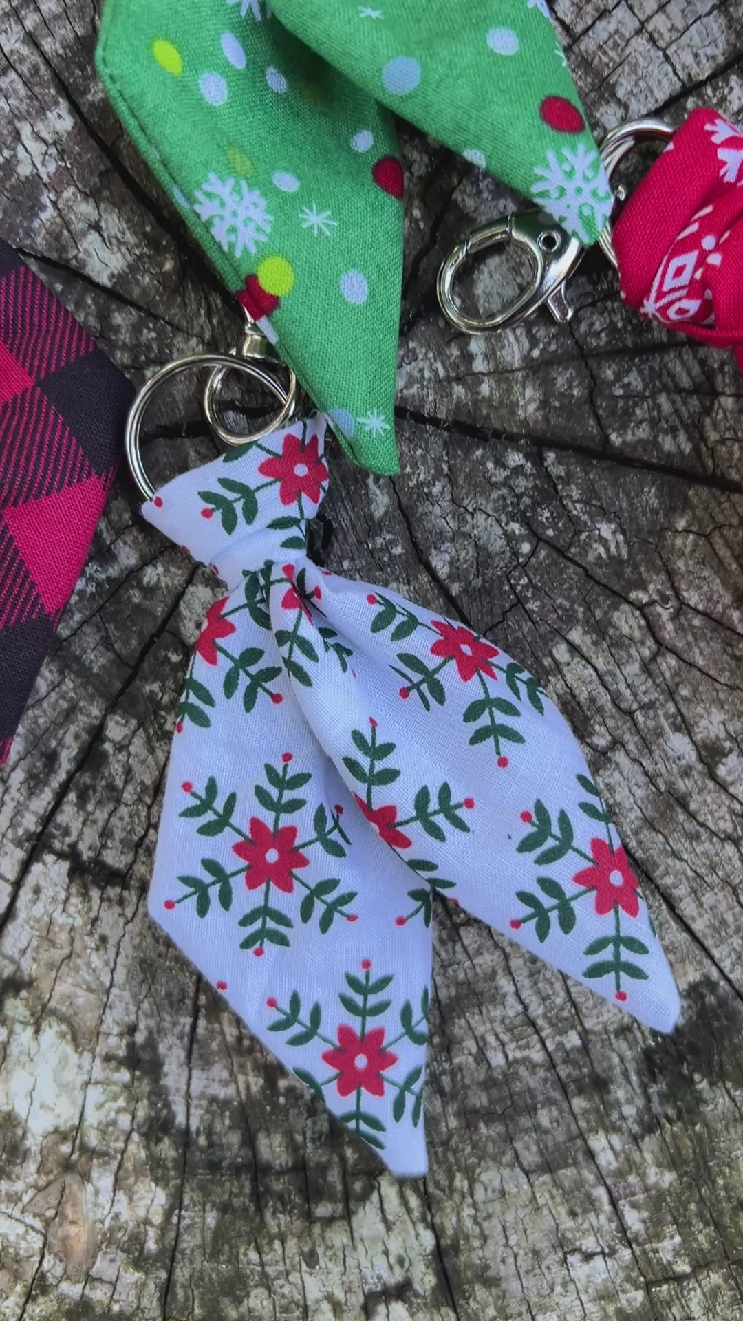 Christmas print mini scarf keychains on wooden surface