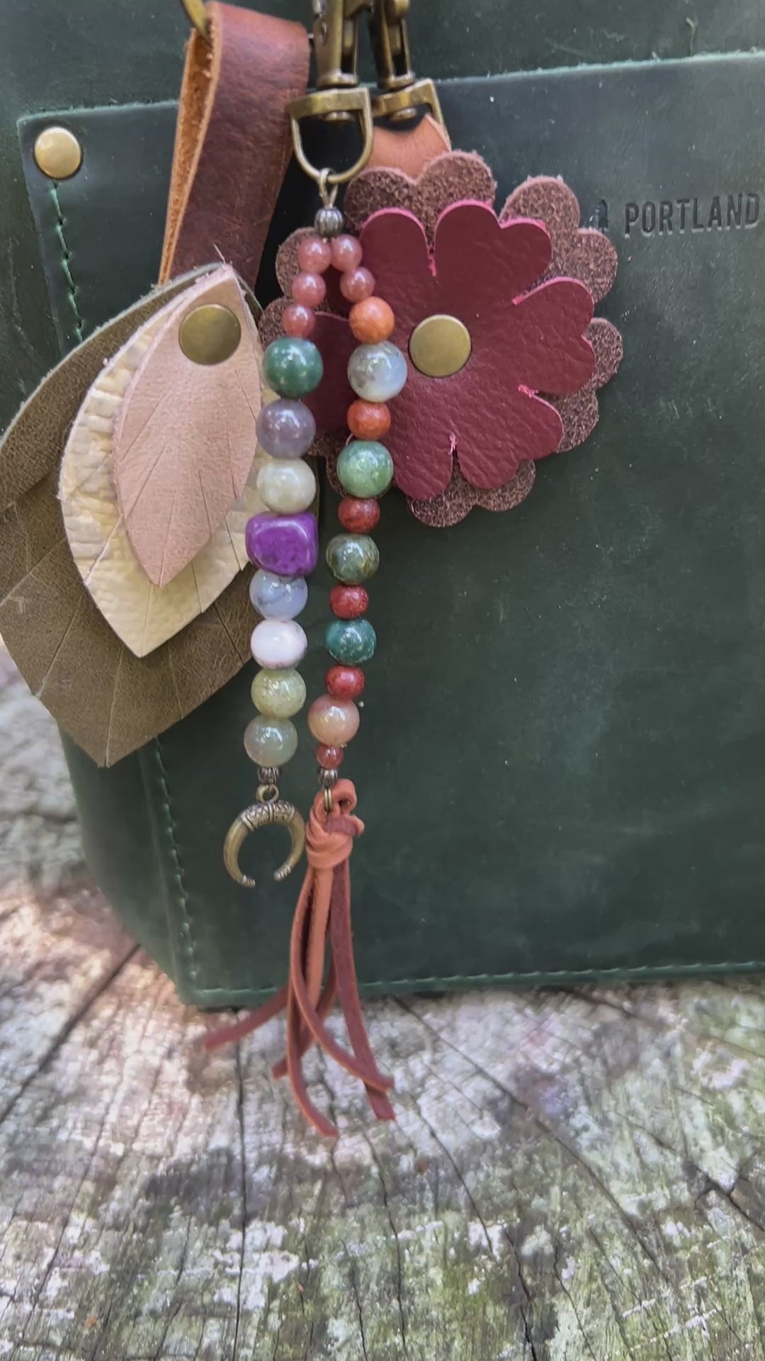 boho beaded bag charm with leather flower and feather on green tote