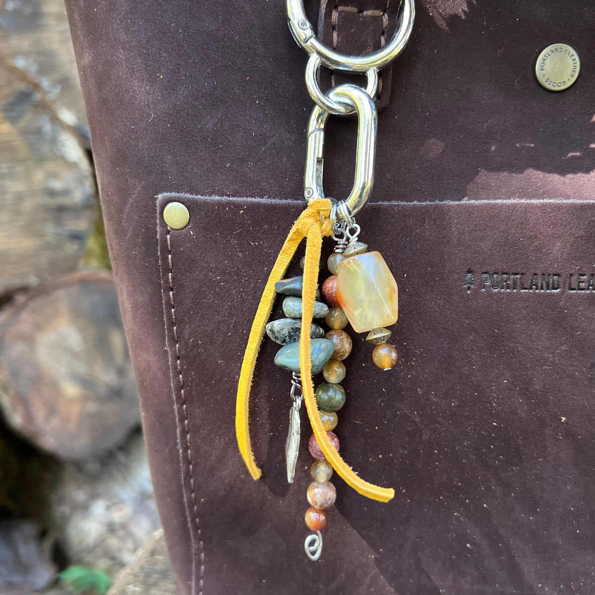 purse charm with yellow tassel and natural stone beads on brown tote