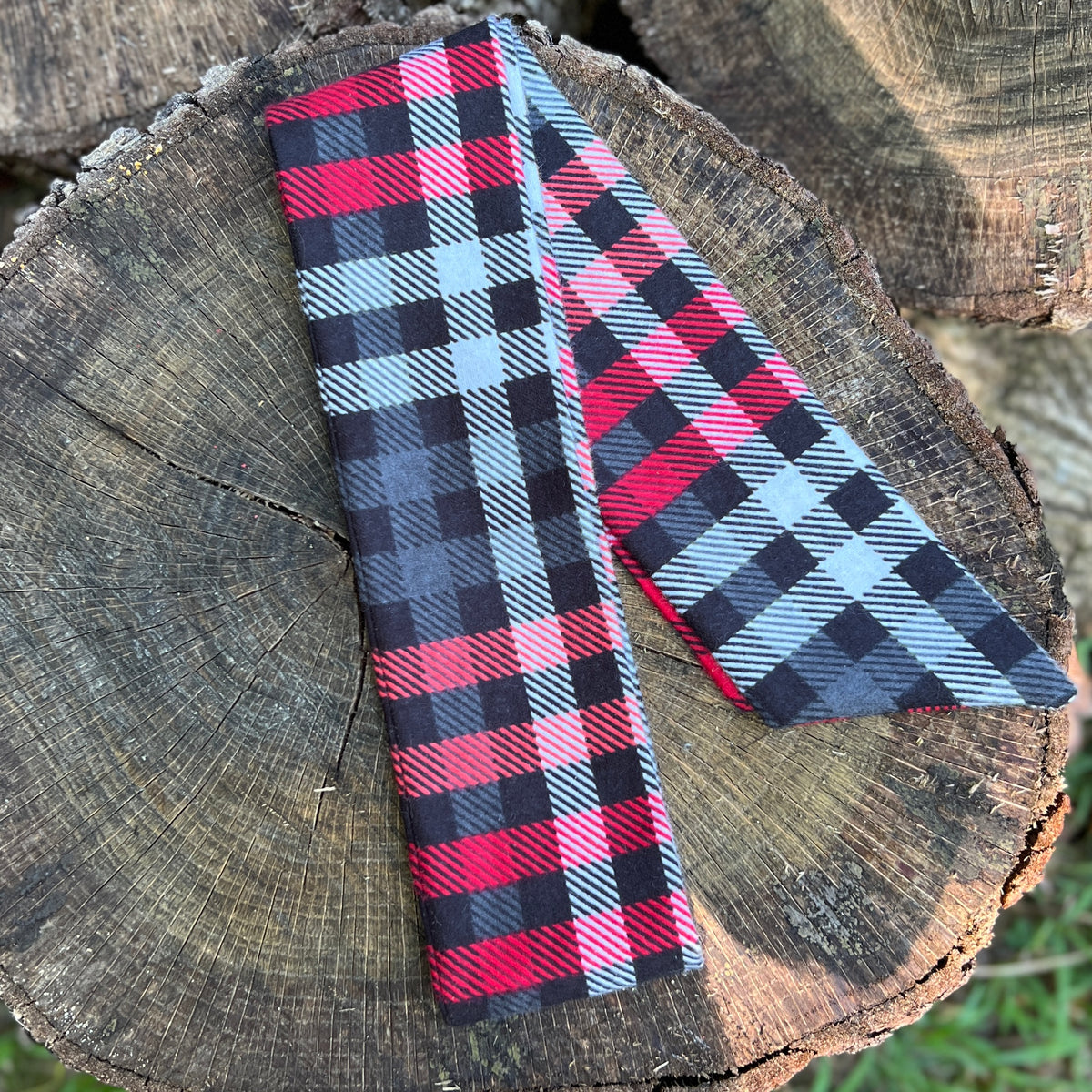 red and black plaid flannel purse scarf on wooden surface