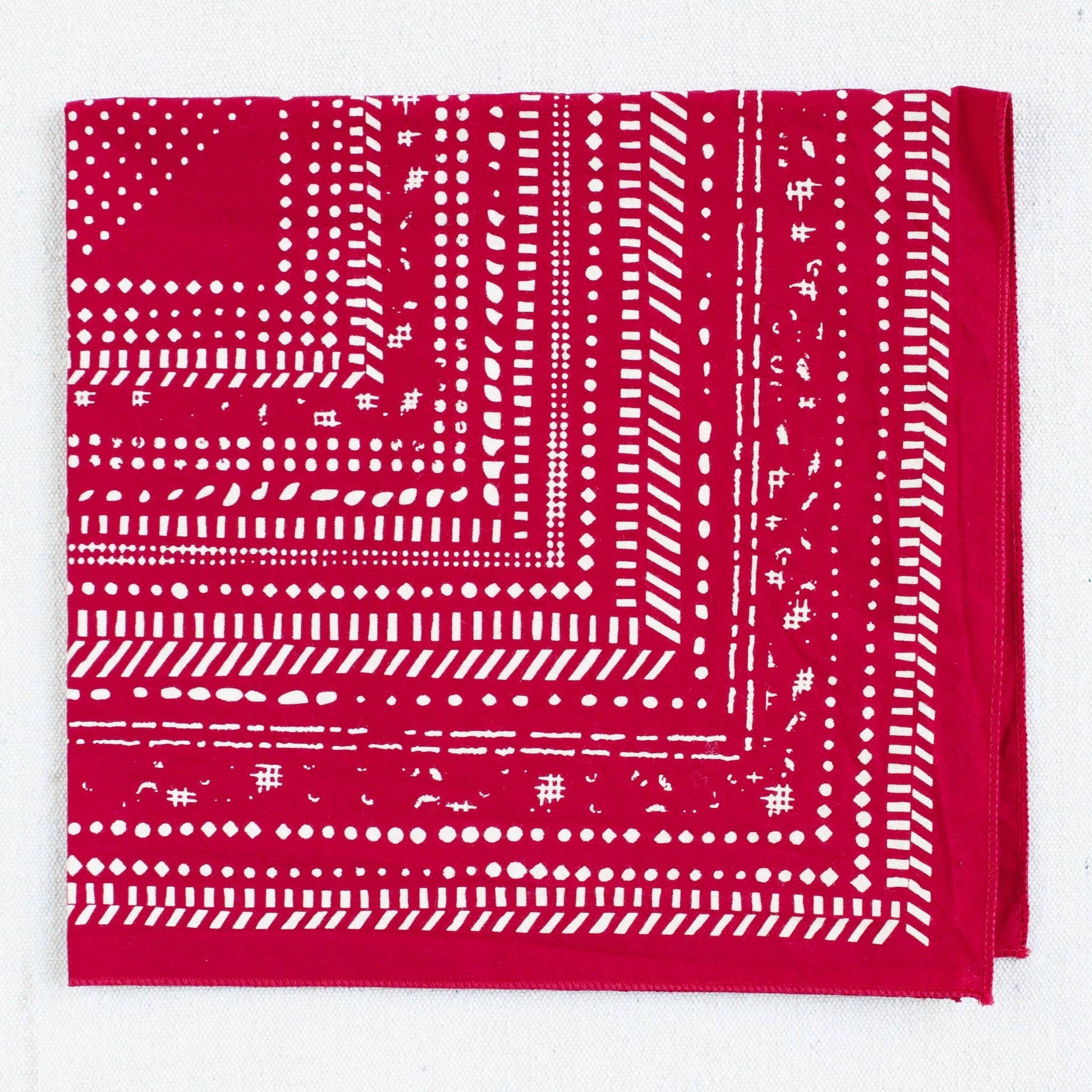 Red bandana with white pattern on a white background