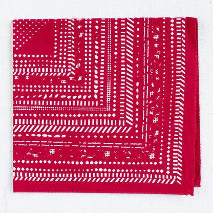 Red bandana with white pattern on a white background