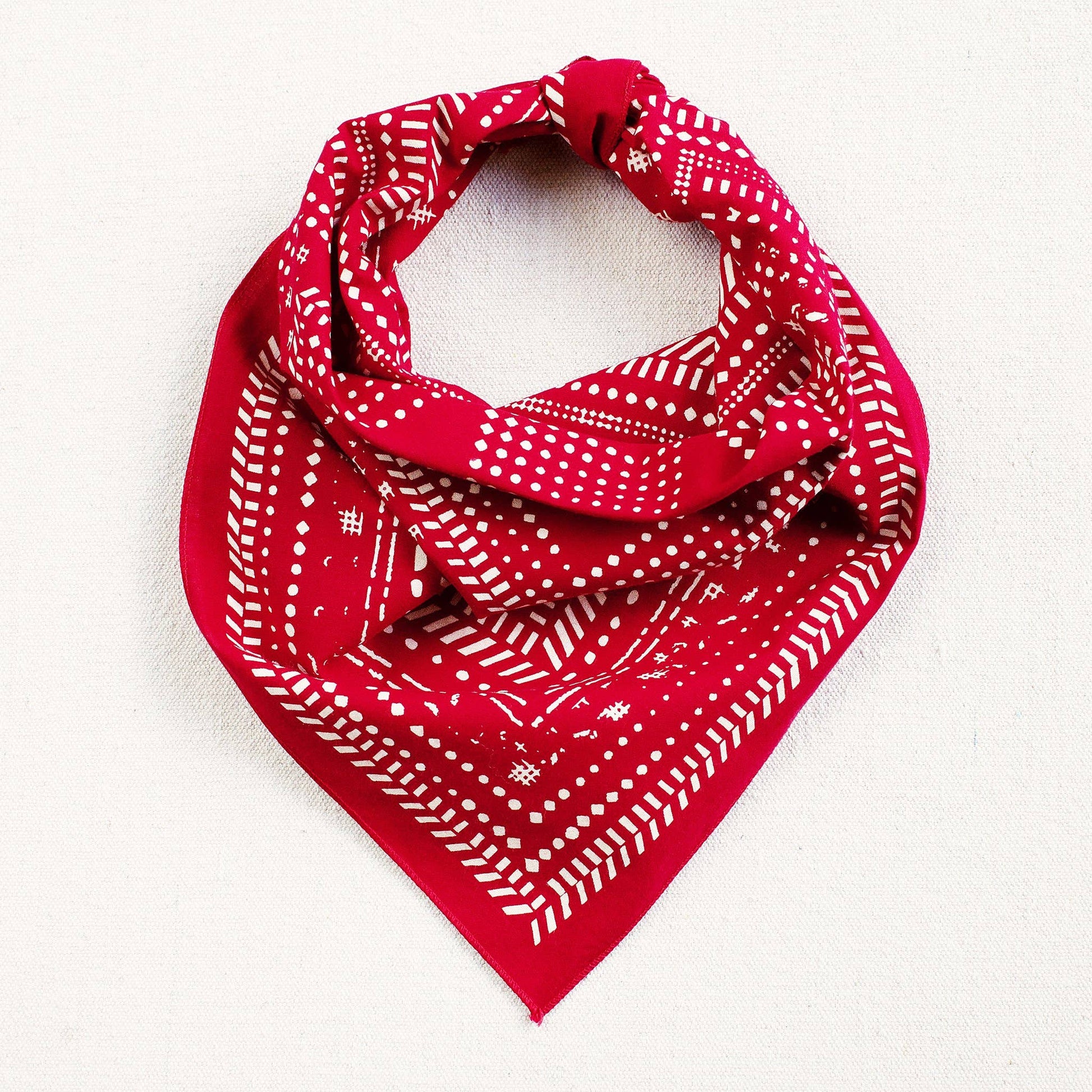 Red bandana with white patterns on a white background