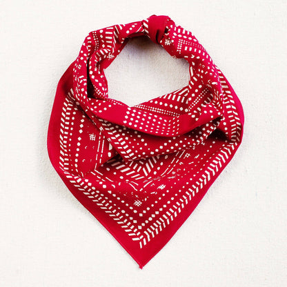 Red bandana with white patterns on a white background