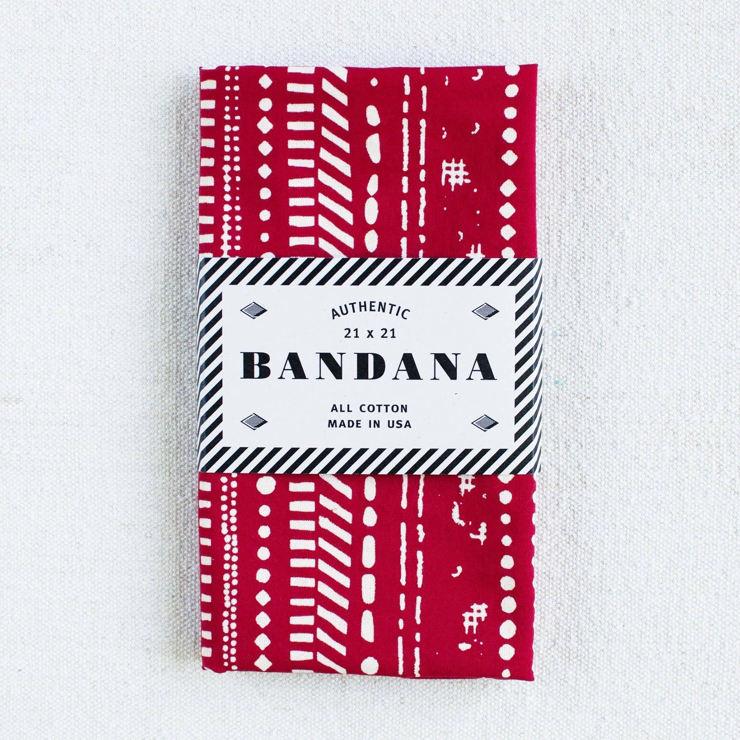 Red and white patterned bandana packaging on a white background