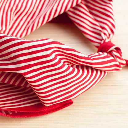Red and white striped bandana on a wooden surface