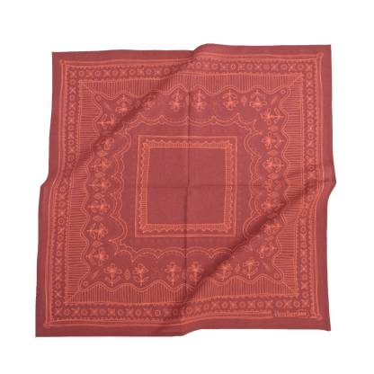 Red bandana with intricate patterns on a white background