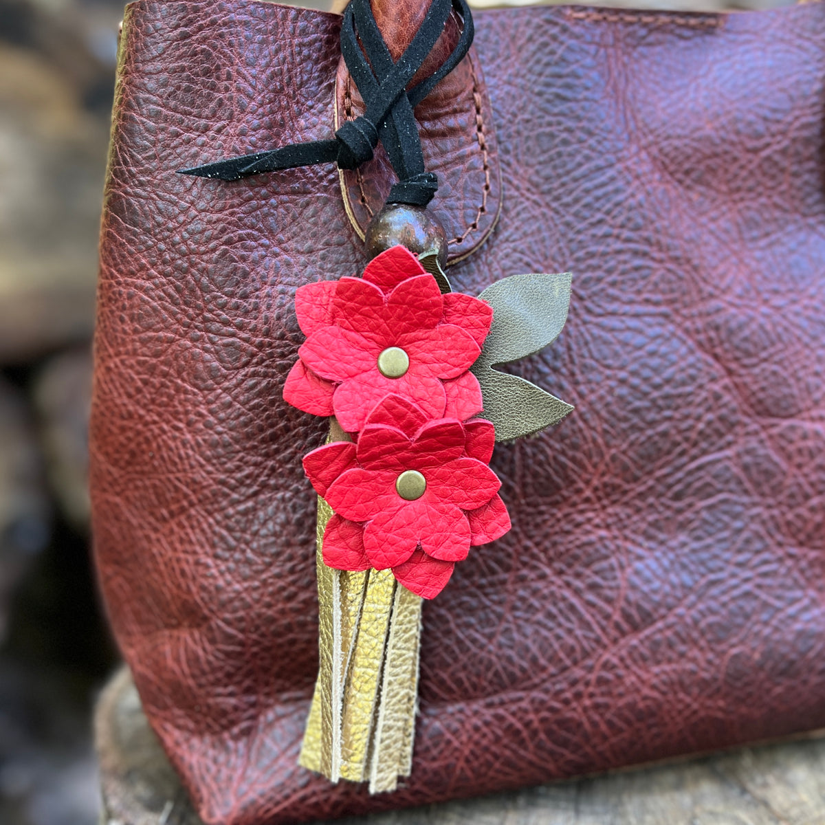 red christmas flowers and gold leather tassel bag charm on brown tote