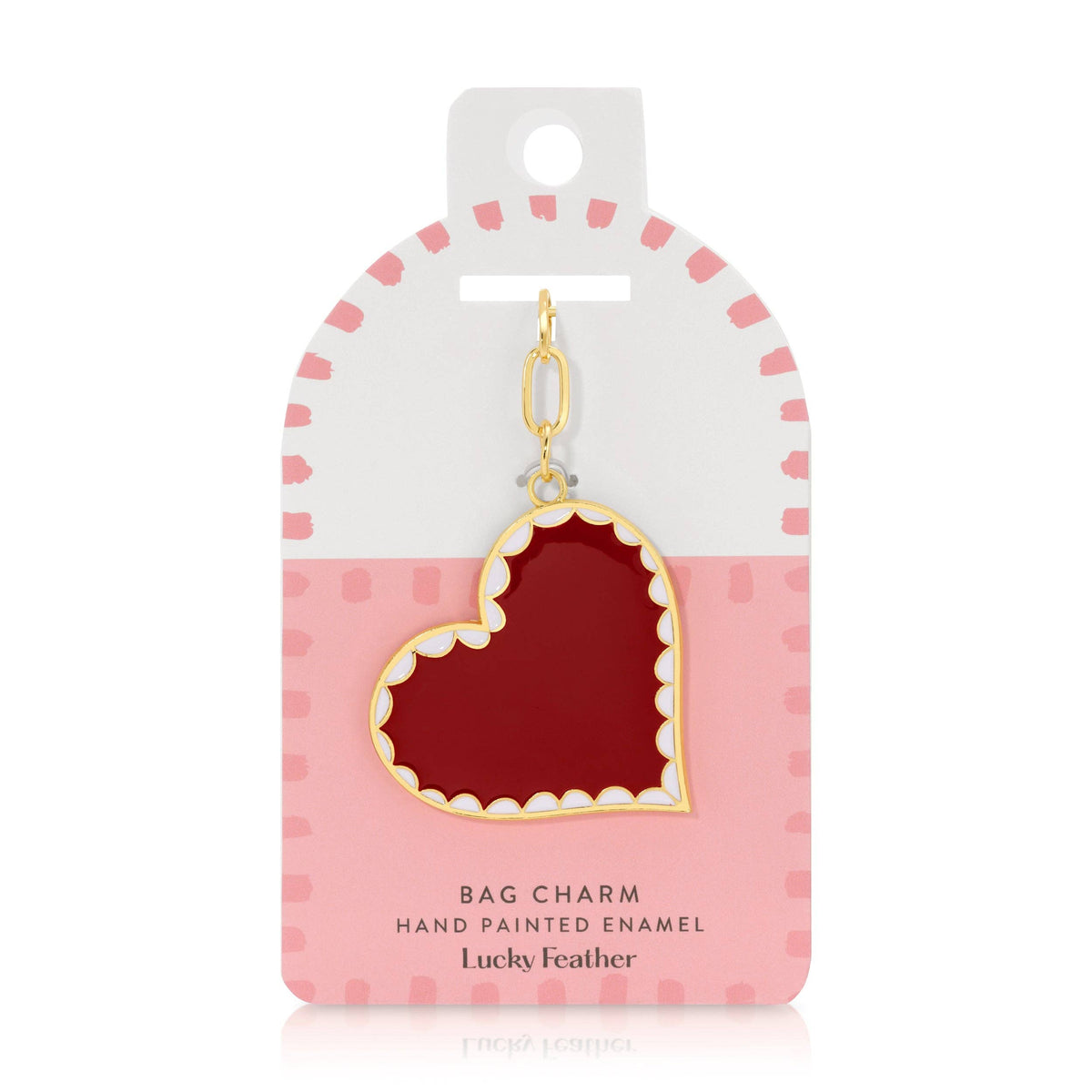 red enameled heart bag charm on white background